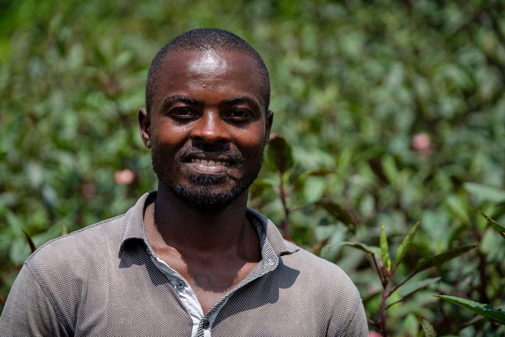 Africa, Andrew, Portrait, Sunshine Agro, UG, UGA, Uganda, agriculture, economic, environment, farm, farm worker, farmer, field, food industry, growth, horizontal, lifestyle, livelihood, looking at camera, making money, natural condition, non-urban, outdoor, plantation, rural scene, work